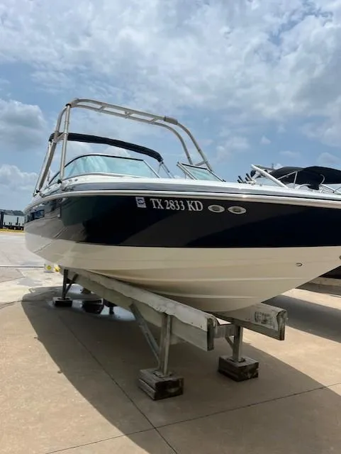 Slide: The Image of 2005 Cobalt 240 boat on trailer under cloudy sky. - 18