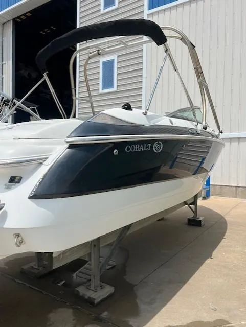 Slide: The Image of 2005 Cobalt 240 boat on a lift, featuring sleek design and black accents. - 20
