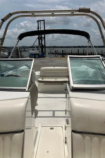 Slide: The Image of 2005 Cobalt 240 boat interior with open deck and seating, docked near water. - 21