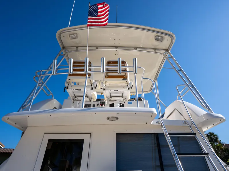 Slide: The Image of 2000 Tiara Yachts 4300 Convertible with American flag, viewed from below against blue sky. - 11