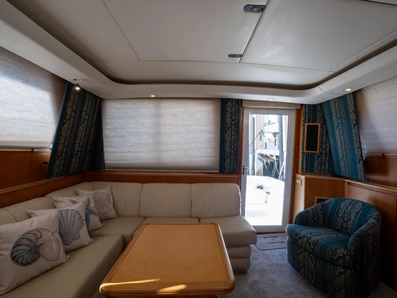 Slide: The Image of Interior of 2000 Tiara Yachts 4300 Convertible with cozy seating and elegant decor. - 13