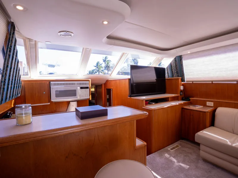Slide: The Image of Interior of 2000 Tiara Yachts 4300 Convertible with modern amenities and natural lighting. - 16