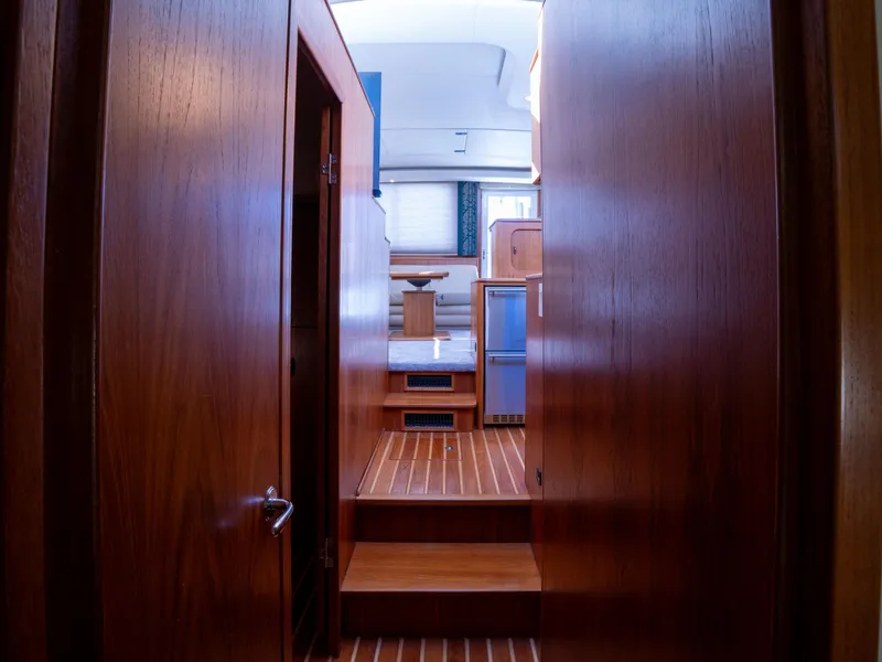 Slide: The Image of Interior view of 2000 Tiara Yachts 4300 Convertible, featuring wooden paneling and cozy cabin space. - 21