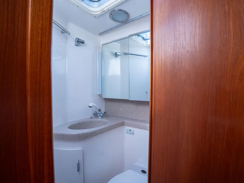 Slide: The Image of Bathroom interior of 2000 Tiara Yachts 4300 Convertible, featuring sink and mirror. - 23