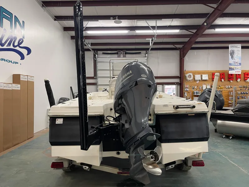 Slide: The Image of 2015 Robalo 226 Cayman boat with Yamaha outboard motor in a showroom. - 10