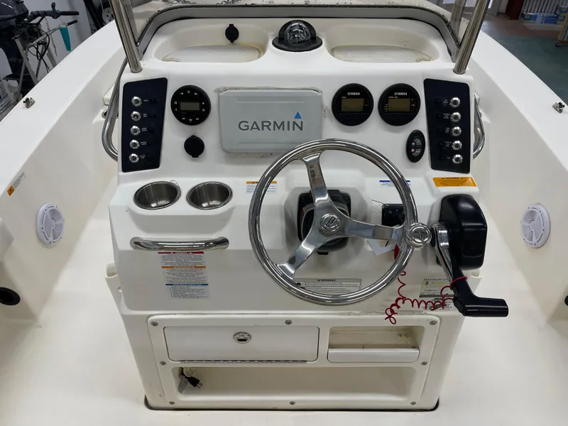 Slide: The Image of 2015 Robalo 226 Cayman boat dashboard with Garmin navigation and steering wheel. - 16