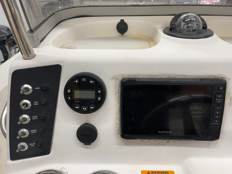 Slide: The Image of Control panel of a 2015 Robalo 226 Cayman boat with Garmin display and switches. - 17
