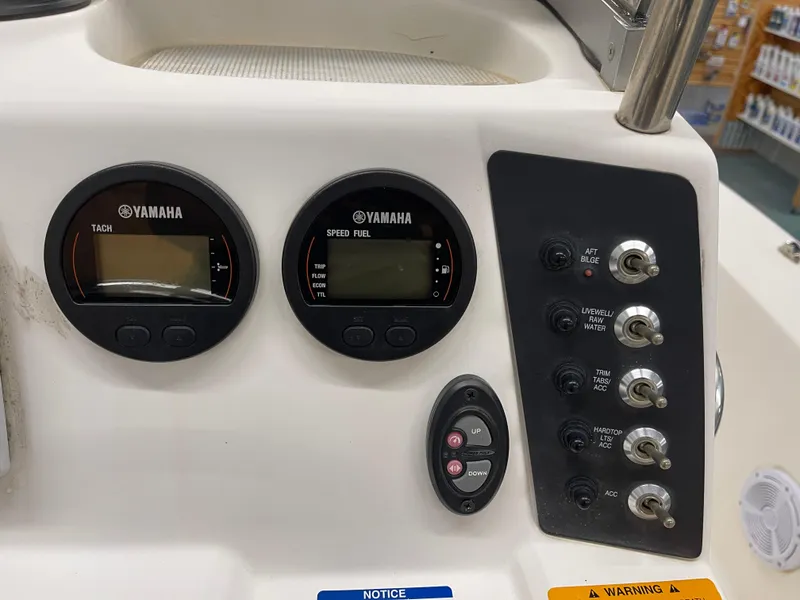 Slide: The Image of Control panel of a 2015 Robalo 226 Cayman boat with Yamaha gauges and switches. - 18
