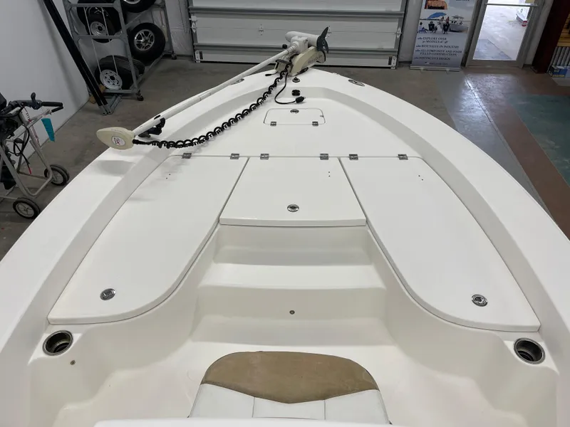 Slide: The Image of 2015 Robalo 226 Cayman boat interior, featuring spacious deck and storage compartments. - 19
