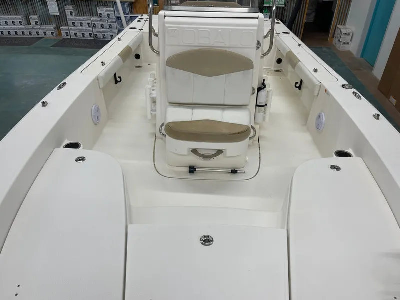 Slide: The Image of 2015 Robalo 226 Cayman boat interior with seating and storage compartments. - 21