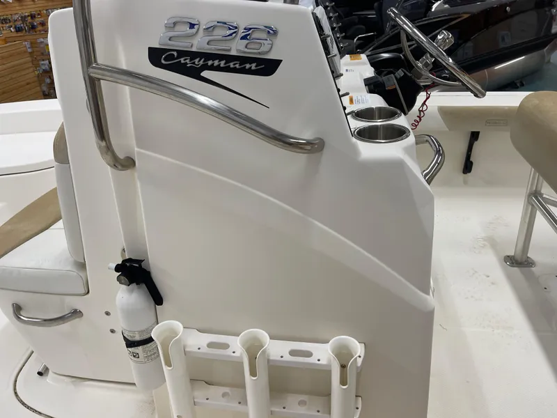 Slide: The Image of 2015 Robalo 226 Cayman boat console with steering wheel and cup holders. - 23