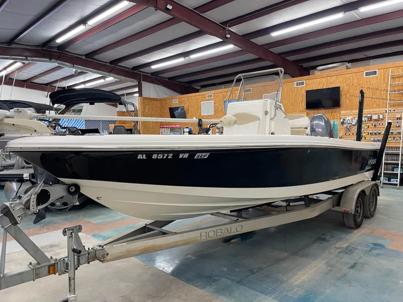 Slide: The Image of 2015 Robalo 226 Cayman boat on trailer in indoor storage facility. - 7