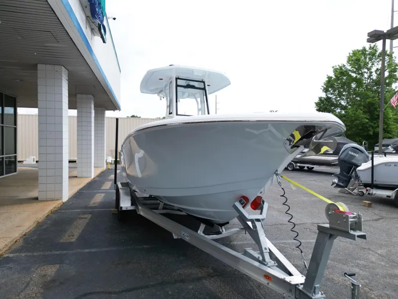 Slide: The Image of 2025 Tidewater 232LXF boat on trailer outside dealership. - 10