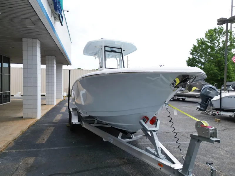 Slide: The Image of 2025 Tidewater 232LXF boat on trailer outside dealership, showcasing sleek design and modern features. - 11