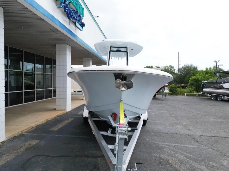 Slide: The Image of 2025 Tidewater 232LXF boat on trailer outside a marine dealership. - 12