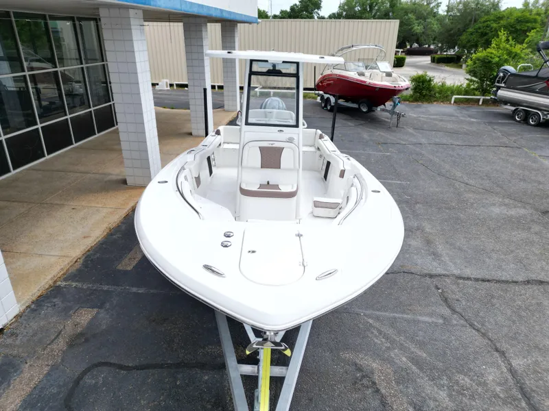 Slide: The Image of 2025 Tidewater 232LXF boat on trailer, parked outside dealership. - 13