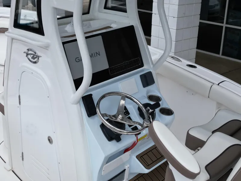 Slide: The Image of 2025 Tidewater 232LXF boat helm with Garmin display and steering wheel. - 18
