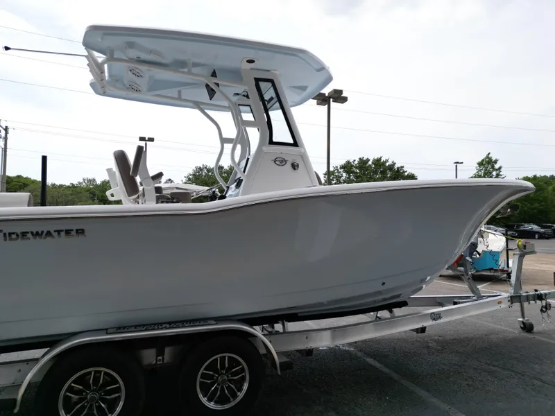 Slide: The Image of 2025 Tidewater 232LXF boat on trailer, side view, showcasing sleek design and modern features. - 21