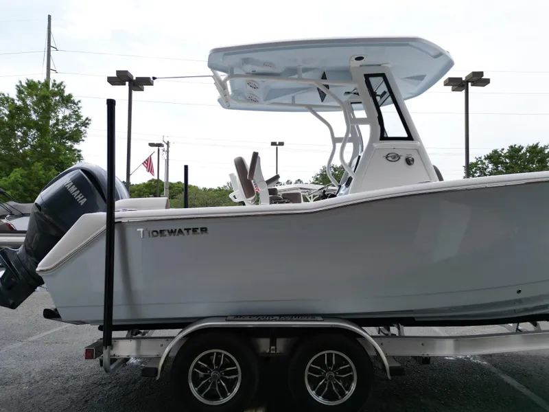 Slide: The Image of 2025 Tidewater 232LXF boat on trailer with Yamaha engine, parked outdoors. - 22