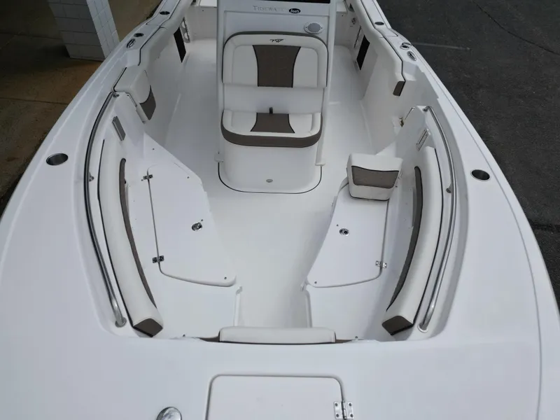 Slide: The Image of 2025 Tidewater 232LXF boat interior with cushioned seating and storage compartments. - 5