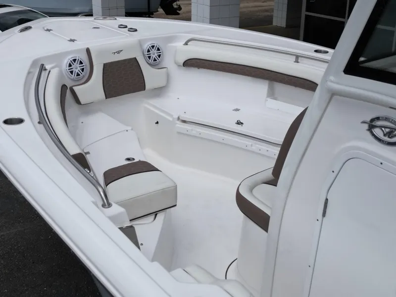Slide: The Image of 2025 Tidewater 232LXF boat interior with cushioned seating and built-in speakers. - 7