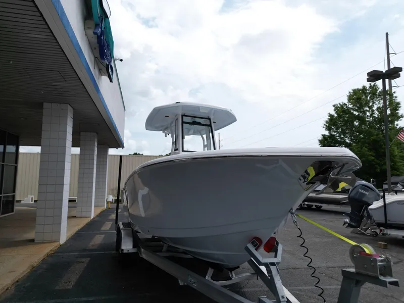 Slide: The Image of 2025 Tidewater 232LXF boat on trailer outside dealership, overcast sky. - 9