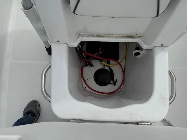 Slide: The Image of 2020 Wellcraft 162 Fisherman boat storage compartment with visible wiring and equipment. - 13