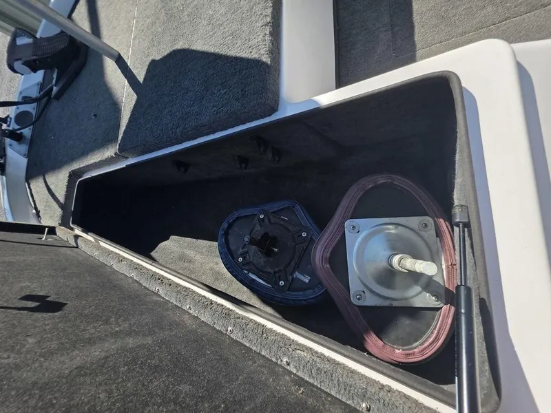 Slide: The Image of Storage compartment in a 1999 Generation III G3 Fiberglass boat, showing interior details. - 12
