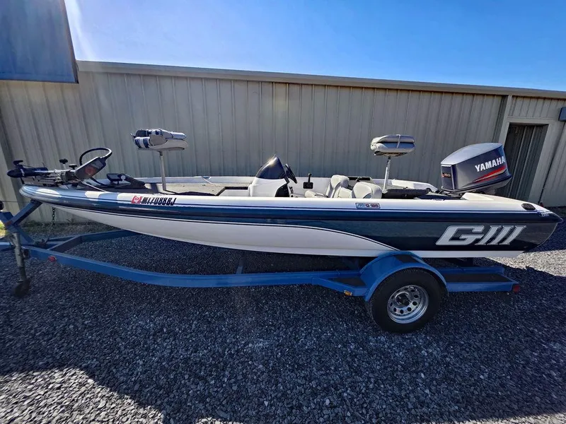 Slide: The Image of 1999 Generation III G3 Fiberglass boat with Yamaha motor on a trailer. - 18