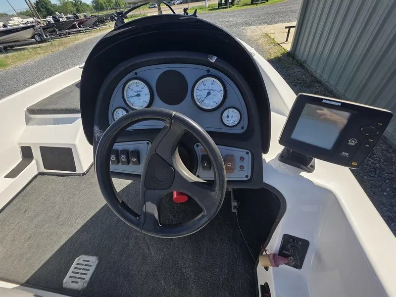 Slide: The Image of Steering console of a 1999 Generation III G3 Fiberglass boat with gauges and controls. - 6