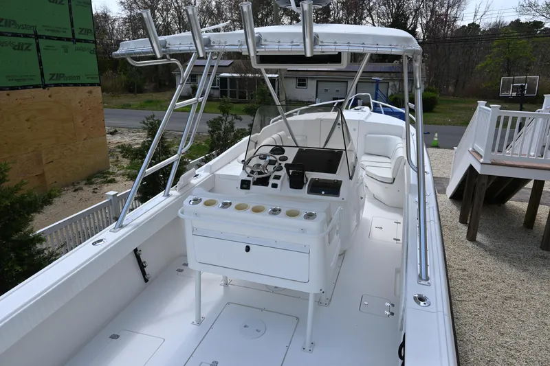 Slide: The Image of 2002 Intrepid 323 Cuddy boat with spacious deck and modern helm controls. - 18