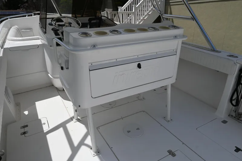 Slide: The Image of 2002 Intrepid 323 Cuddy boat interior with helm and seating area. - 24