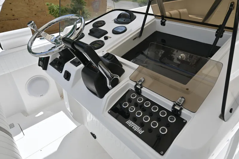 Slide: The Image of 2002 Intrepid 323 Cuddy helm with steering wheel and control panel. - 31