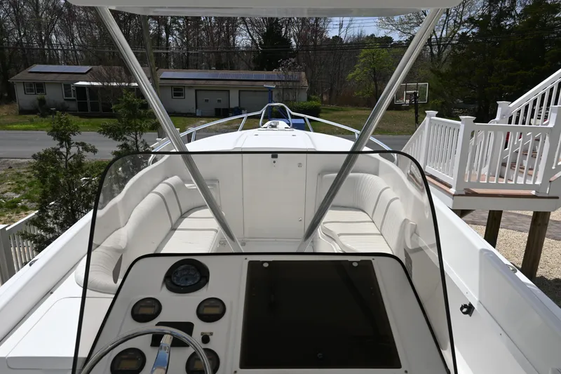 Slide: The Image of 2002 Intrepid 323 Cuddy boat with spacious seating and modern dashboard controls. - 34