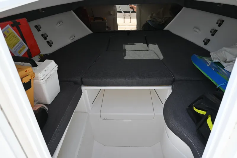 Slide: The Image of 2002 Intrepid 323 Cuddy cabin interior with storage and seating. - 39