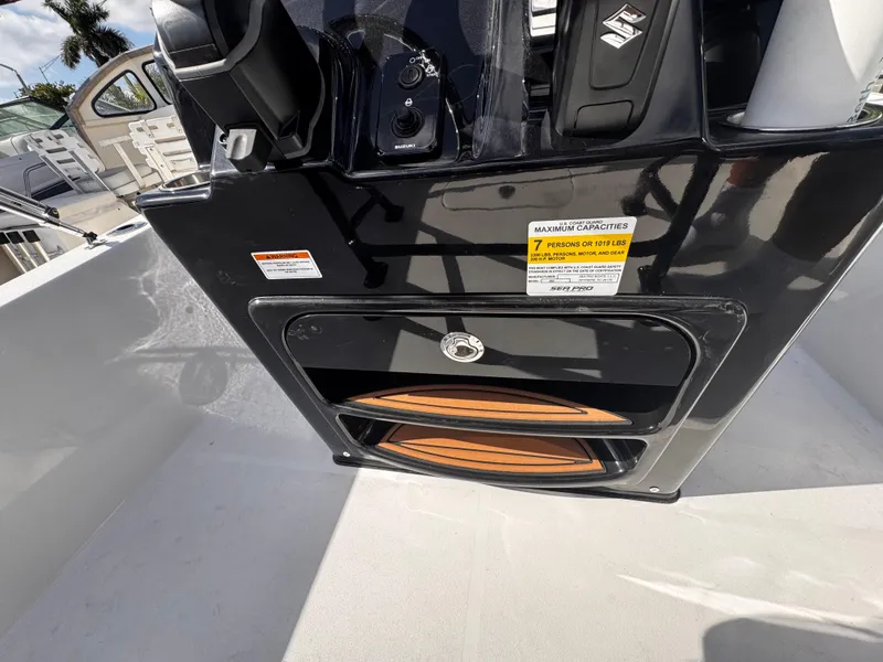 Slide: The Image of 2025 Sea Pro 202 Center Console boat interior with control panel and storage compartment. - 12