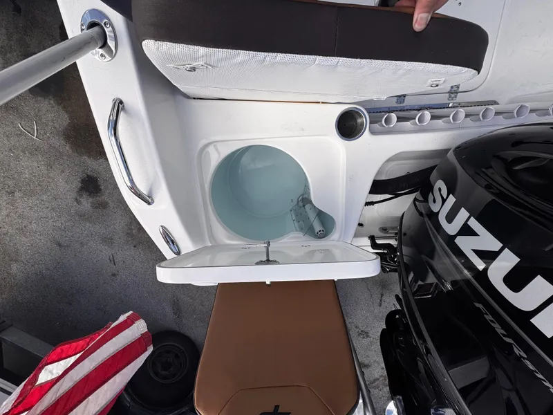 Slide: The Image of 2025 Sea Pro 202 Center Console boat interior with Suzuki engine and storage compartment. - 14