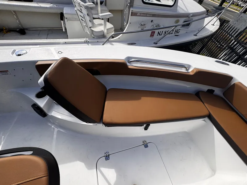Slide: The Image of 2025 Sea Pro 202 Center Console boat with brown cushioned seating. - 17