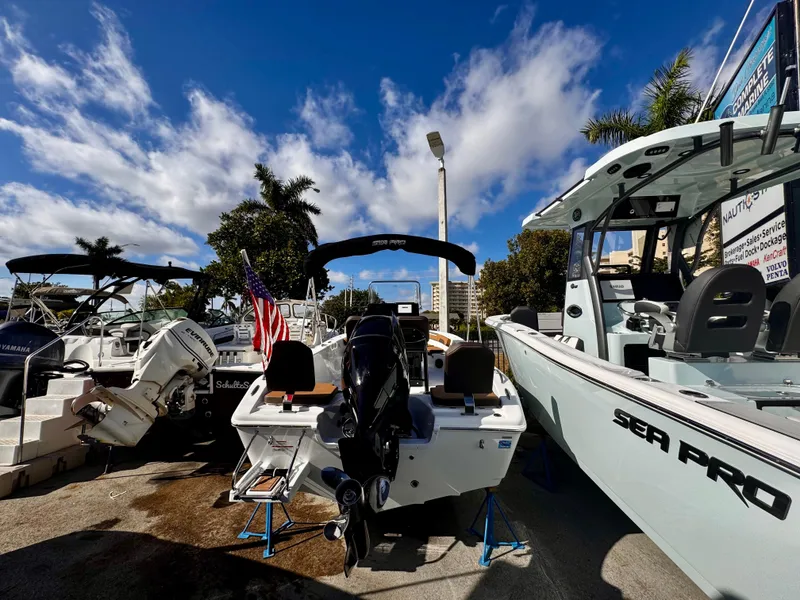 Slide: The Image of 2025 Sea Pro 202 Center Console boat displayed outdoors under a blue sky. - 2