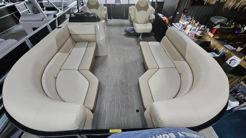 Slide: The Image of 2024 Veranda Vista 20RC pontoon boat interior with beige seating and modern design. - 10