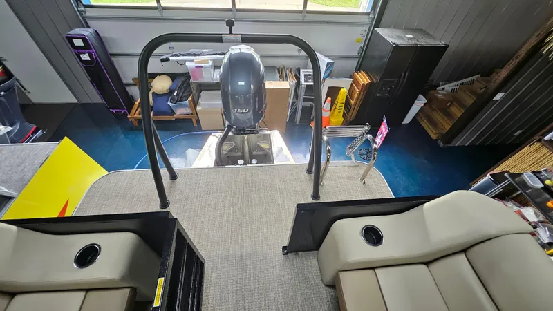 Slide: The Image of 2024 Veranda Vista 20RC boat interior with seating and motor in a showroom. - 12