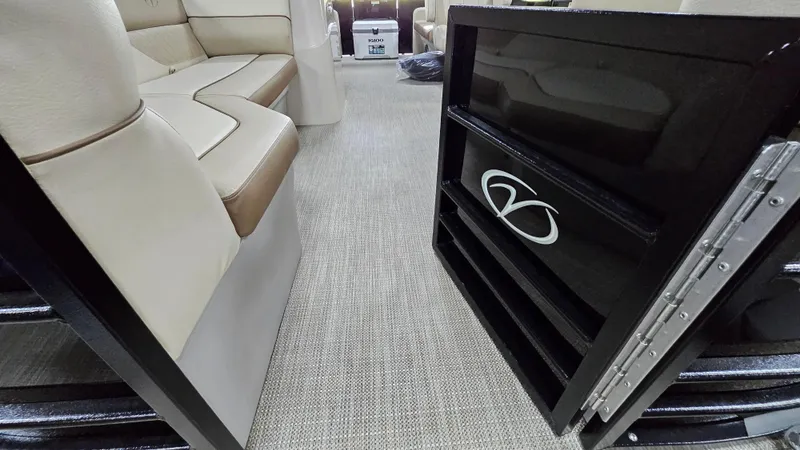 Slide: The Image of 2024 Veranda Vista 20RC interior with beige seating and open storage compartment. - 2