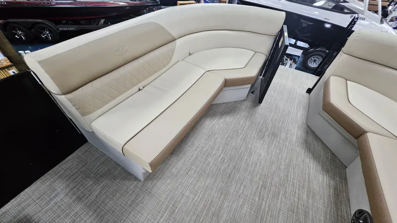 Slide: The Image of 2024 Veranda Vista 20RC boat interior with beige seating and carpeted flooring. - 6