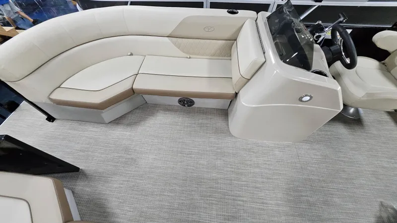 Slide: The Image of 2024 Veranda Vista 20RC boat interior with beige seating and modern dashboard. - 8