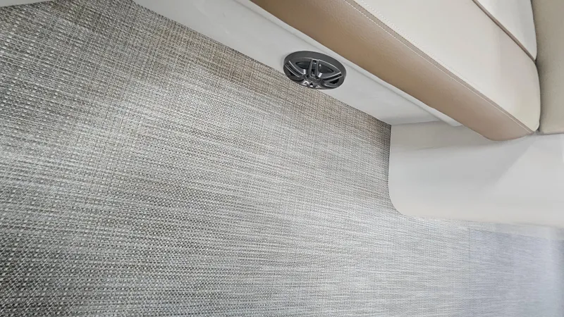 Slide: The Image of 2024 Veranda Vista 20RC interior with textured flooring and beige seating. - 9