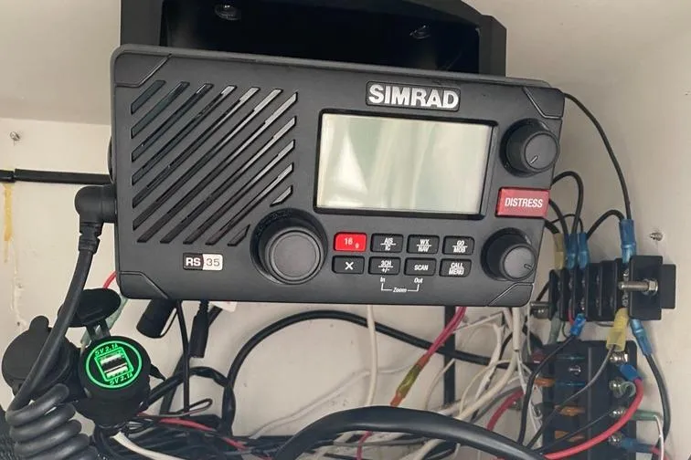 Slide: The Image of Simrad RS35 radio on 2004 Cobia 270 Walk-Around boat, surrounded by wiring. - 6