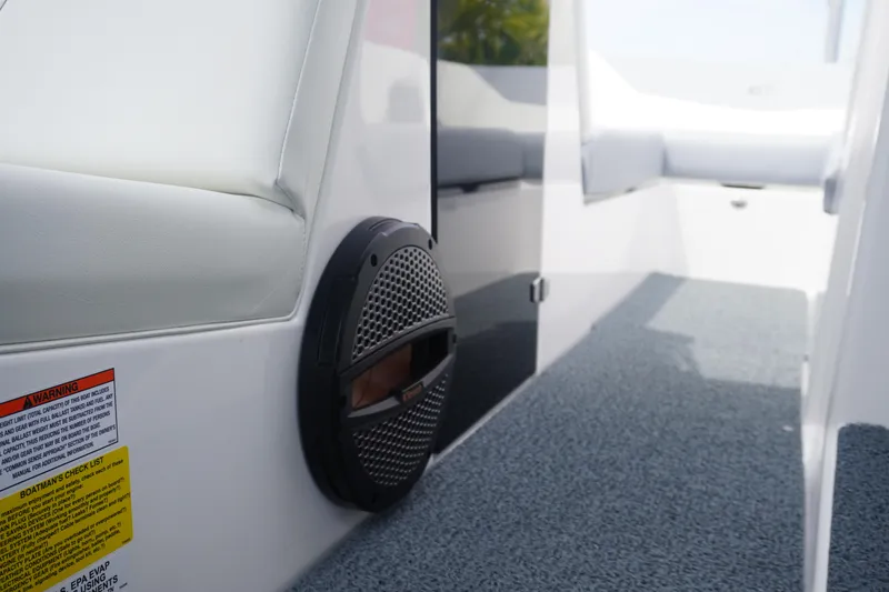 Slide: The Image of 2023 MasterCraft NXT24 interior with speaker and carpeted flooring. - 12