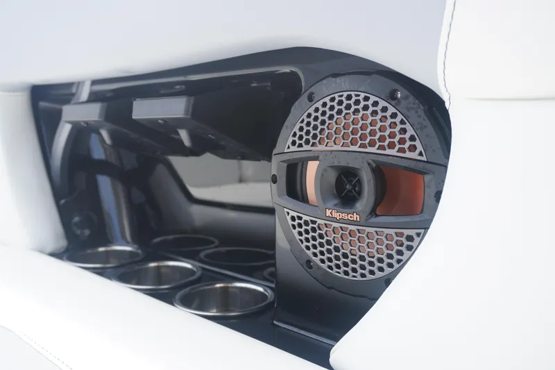 Slide: The Image of 2023 MasterCraft NXT24 boat interior featuring Klipsch speaker and cup holders. - 14