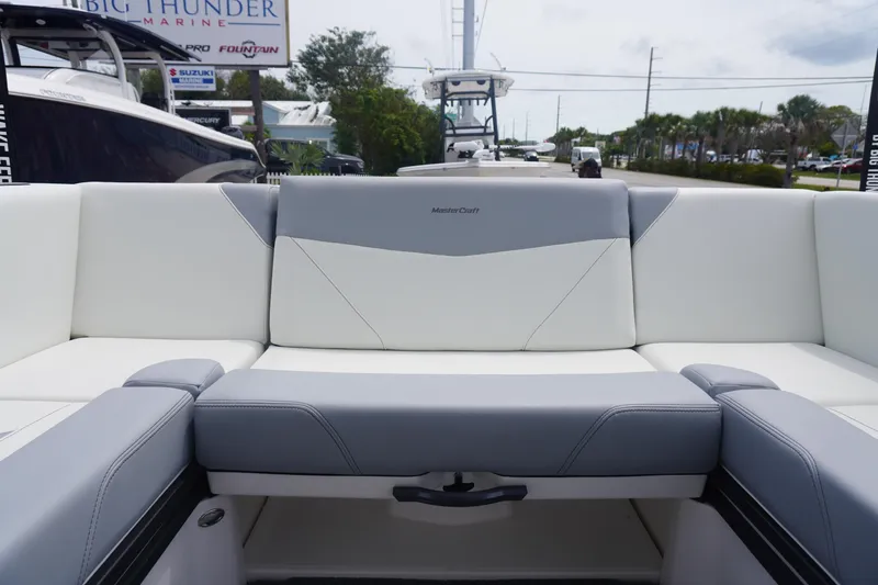 Slide: The Image of 2023 MasterCraft NXT24 boat interior with gray and white seating. - 17