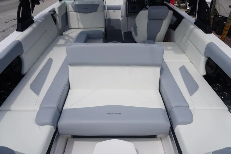 Slide: The Image of 2023 MasterCraft NXT24 boat interior with white and gray seating. - 18